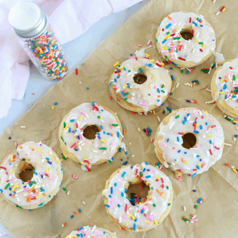Golden Air Fryer Cake Mix Donuts topped with sweet glaze and colorful sprinkles.
