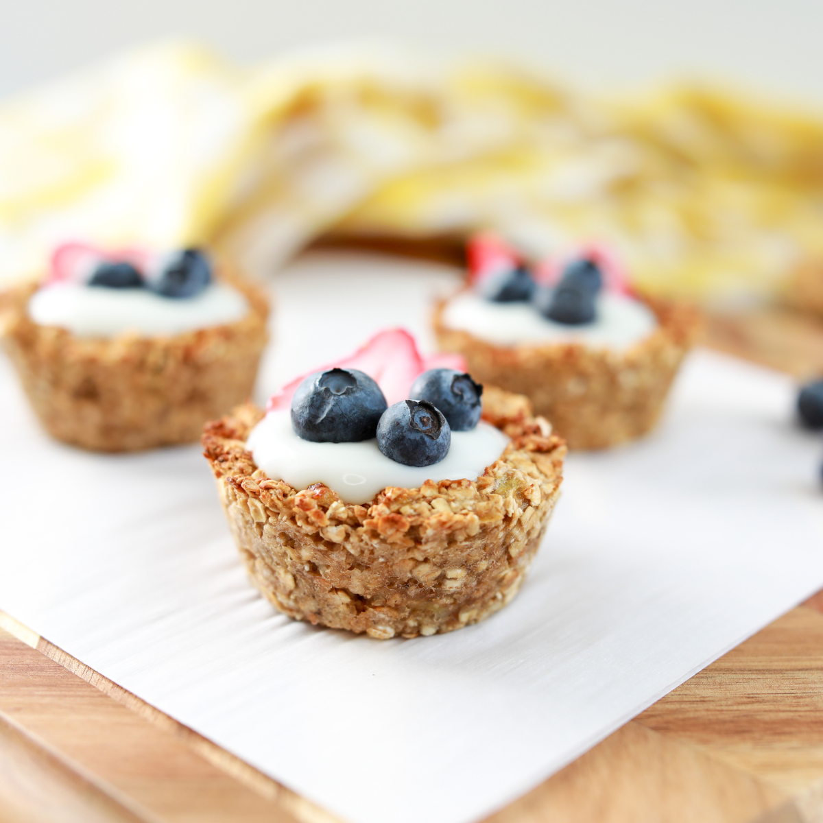 Air Fryer Oatmeal Bites on white paper and yellow napkin in background