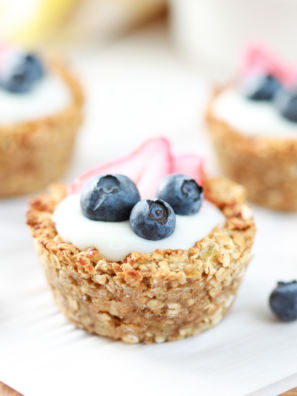 Air fryer oatmeal bites topped with yogurt and fresh berries on a white plate