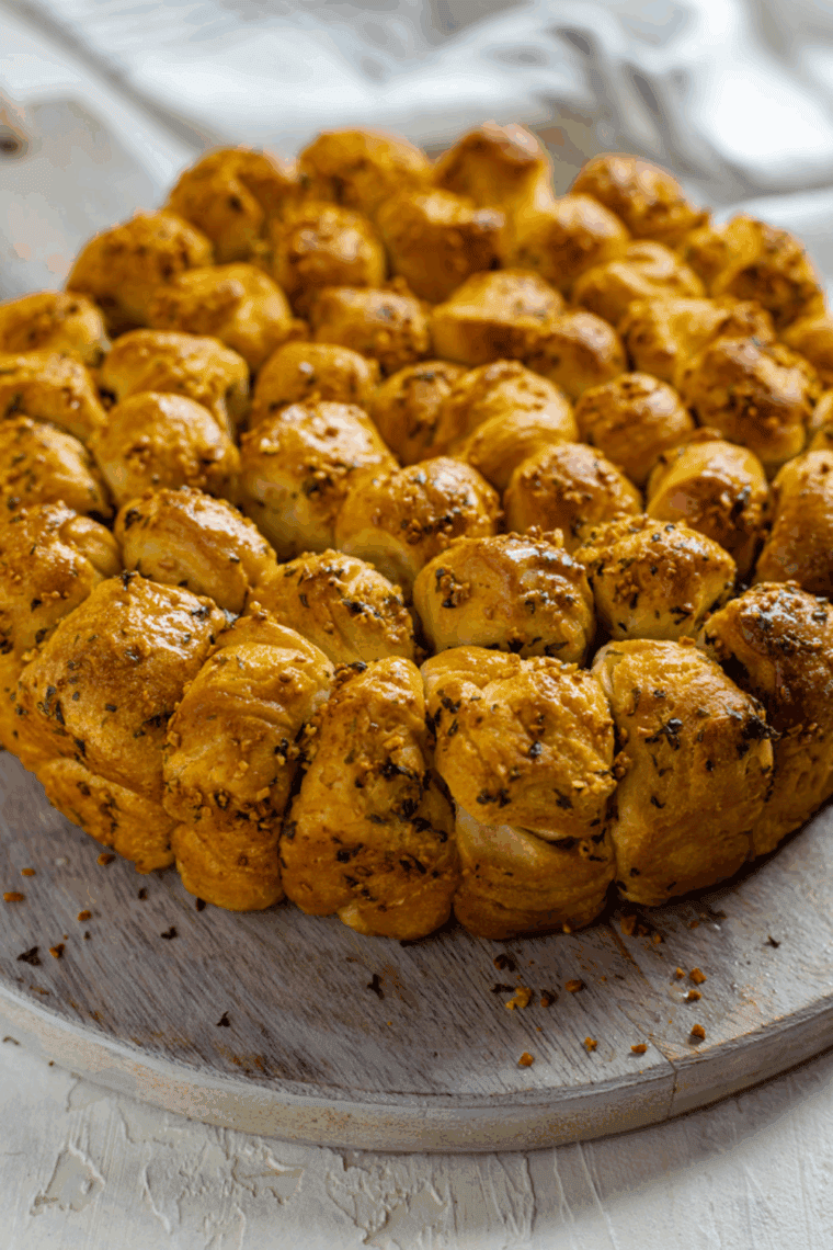 Golden brown Air Fryer Parmesan and Herb Bubble Bread in a loaf pan, showing the cheesy, pull-apart texture.