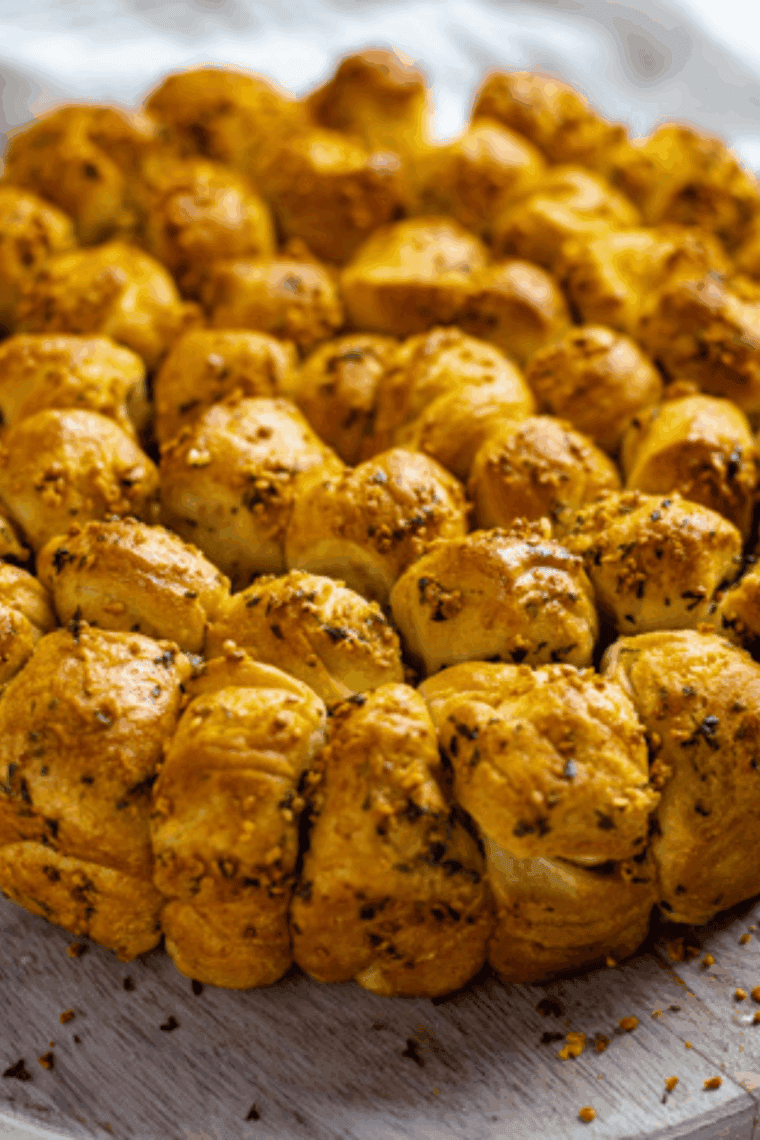 Golden brown Air Fryer Parmesan and Herb Bubble Bread in a loaf pan, showing the cheesy, pull-apart texture.