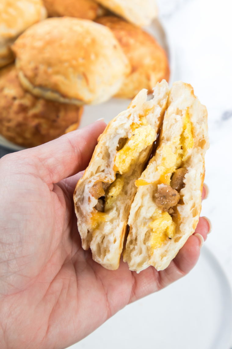 Golden air fryer sausage biscuits stacked on a plate, ready to serve