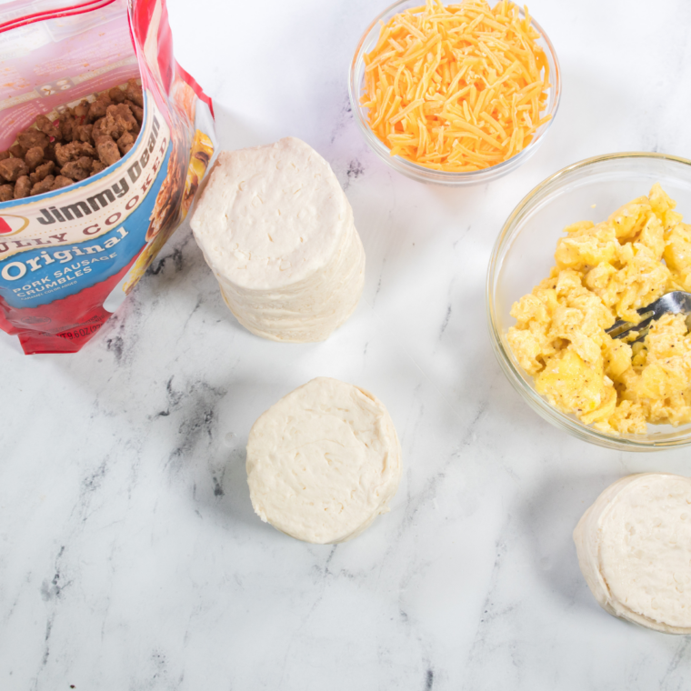 Air fryer sausage biscuits ingredients: refrigerated biscuits, sausage, eggs, and shredded cheese