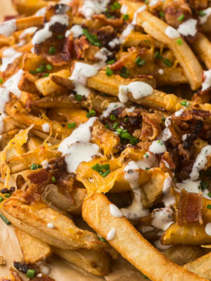 Chili's Texas Cheese Fries copycat recipe in a skillet with melted cheese, bacon, jalapeños, and ranch