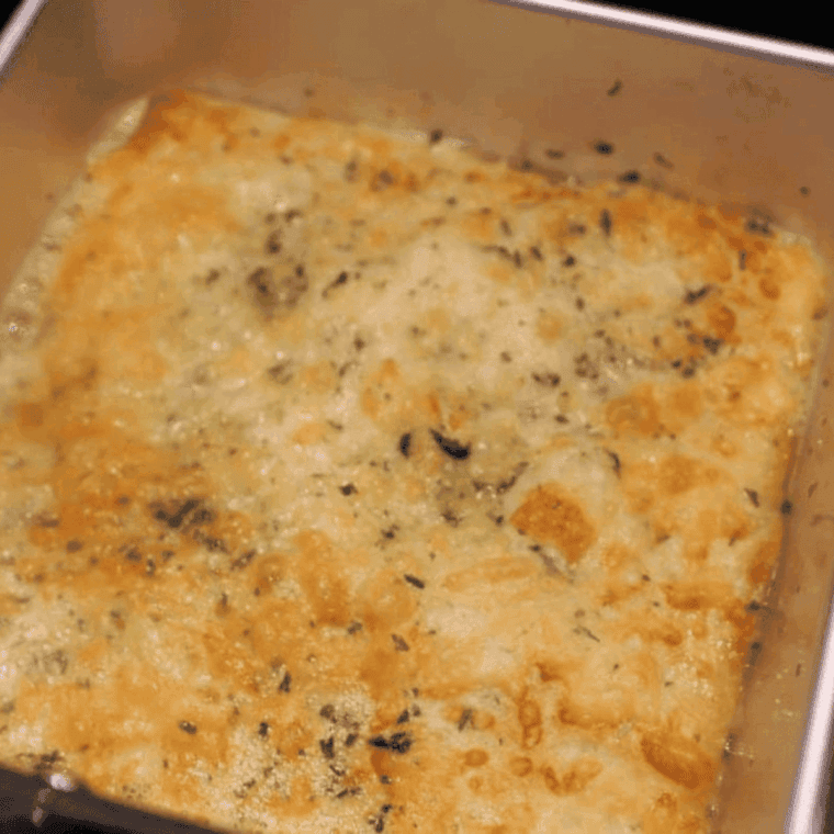 Cooked cheese bread in the air fryer basket.