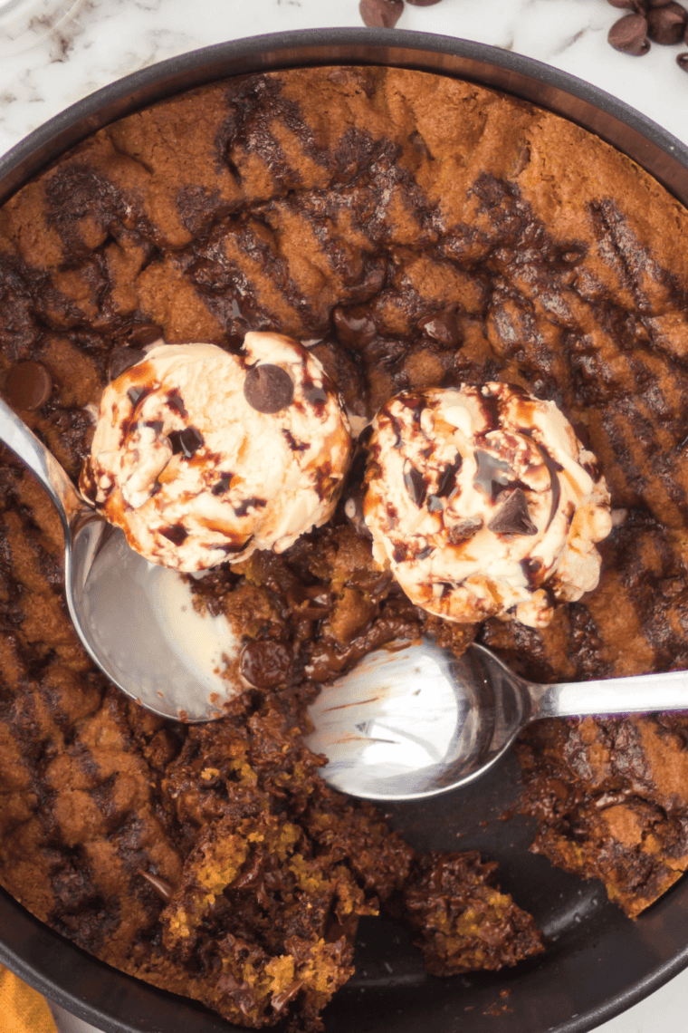 Golden, gooey chocolate chip skillet cookie fresh from the air fryer, loaded with melted chocolate chips.