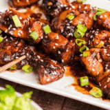 Close-up of sticky, spicy firecracker chicken bites ready to serve.