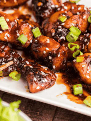 Close-up of sticky, spicy firecracker chicken bites ready to serve.