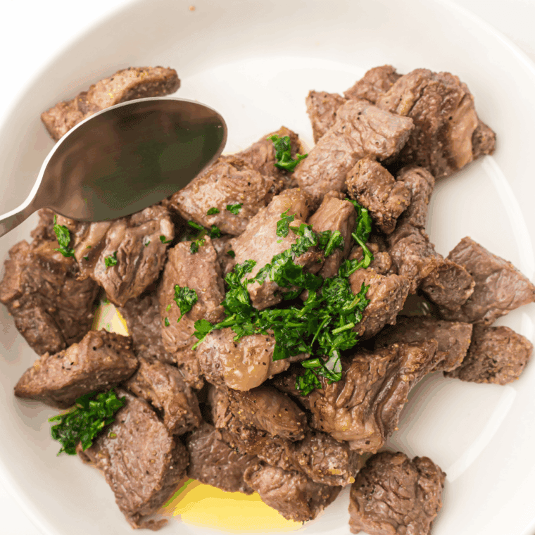 Air fryer bourbon marinated steak tips, golden-brown and juicy, served on a plate