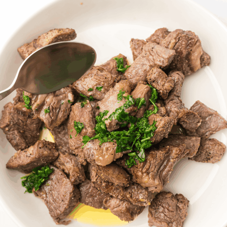 Air fryer bourbon marinated steak tips, golden-brown and juicy, served on a plate
