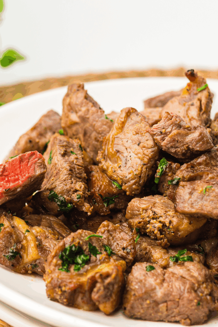 Golden, juicy bourbon marinated steak tips cooked and plated, ready to serve