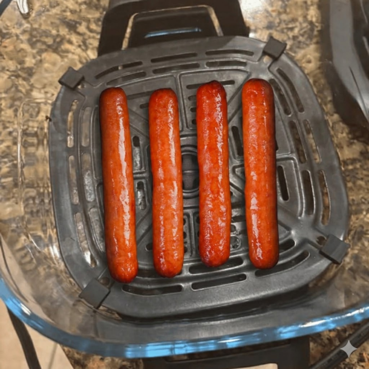 Hot dog buns toasting in air fryer until warm, soft, and lightly crisp.