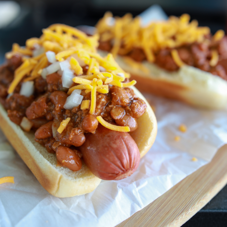 Crispy hot dogs assembled in buns with toppings ready to serve immediately.