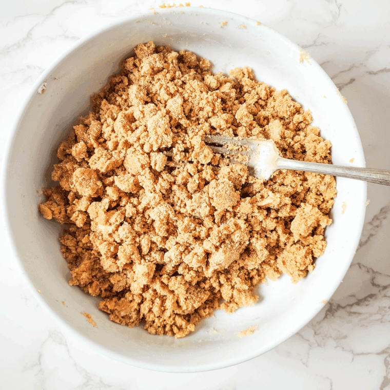 Combining granulated sugar, brown sugar, cinnamon, melted butter, and nuts to make crumb topping.