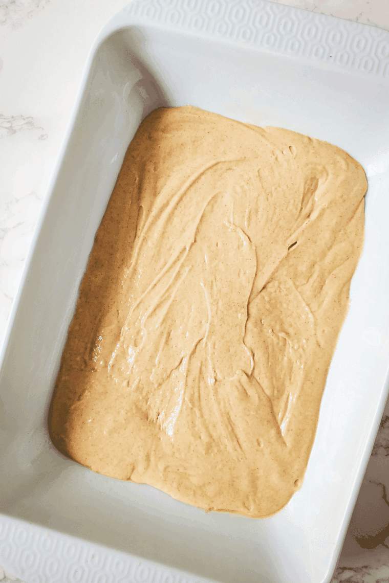 Pouring cake batter into pan and sprinkling cinnamon crumb topping evenly on top.
