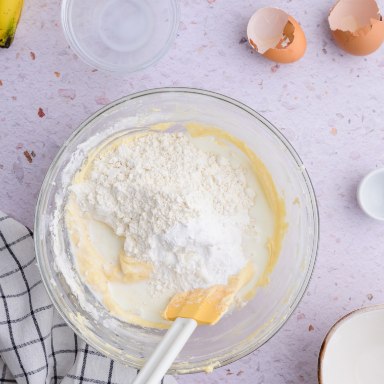 Banana bread batter being folded with a spatula until just combined