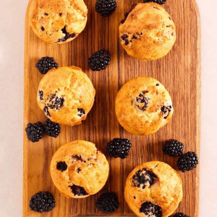 Golden air fryer muffins with juicy blackberries, zesty lemon, and sprinkled poppy seeds