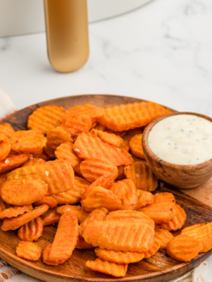 A plate of crispy Air Fryer Carrot Chips, showcasing perfectly air-fried carrots with tender centers and crispy edges, ideal for a tasty side dish or snack.