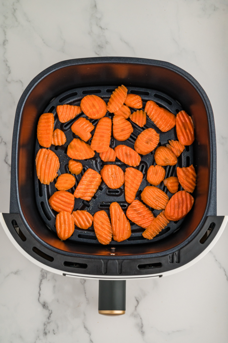 An air fryer with the temperature dial set, indicating it's preheating for cooking.