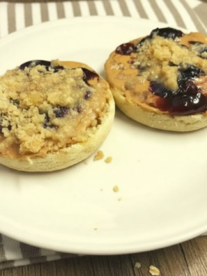 Air fryer toasted English muffins topped with peanut butter, jelly, and golden oat streusel crumble.