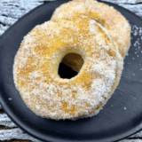 Golden Cinnamon Sugar Air Fryer Biscuit Donuts coated in cinnamon sugar on a plate.