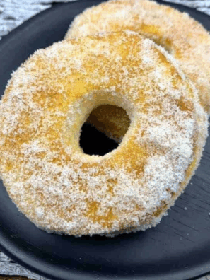 Golden Cinnamon Sugar Air Fryer Biscuit Donuts coated in cinnamon sugar on a plate.