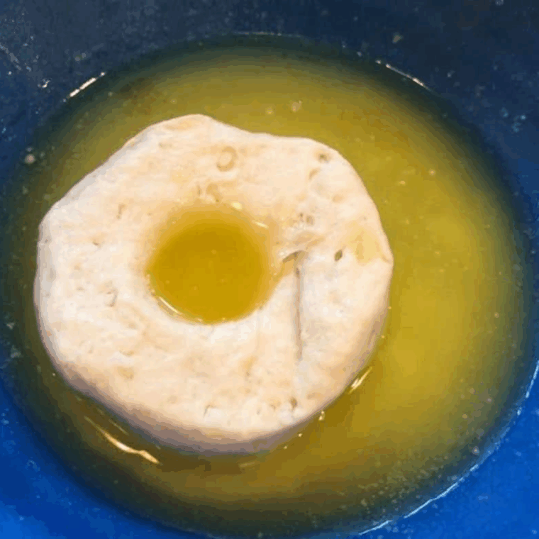 Soak the biscuit dough into the melted butter.