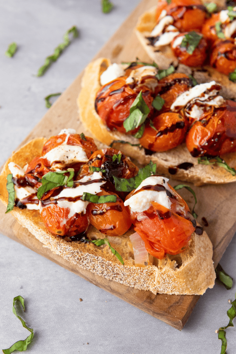 Toasted baguette slices topped with fresh tomato, basil, garlic, and balsamic glaze for a delicious Copycat Olive Garden Bruschetta.