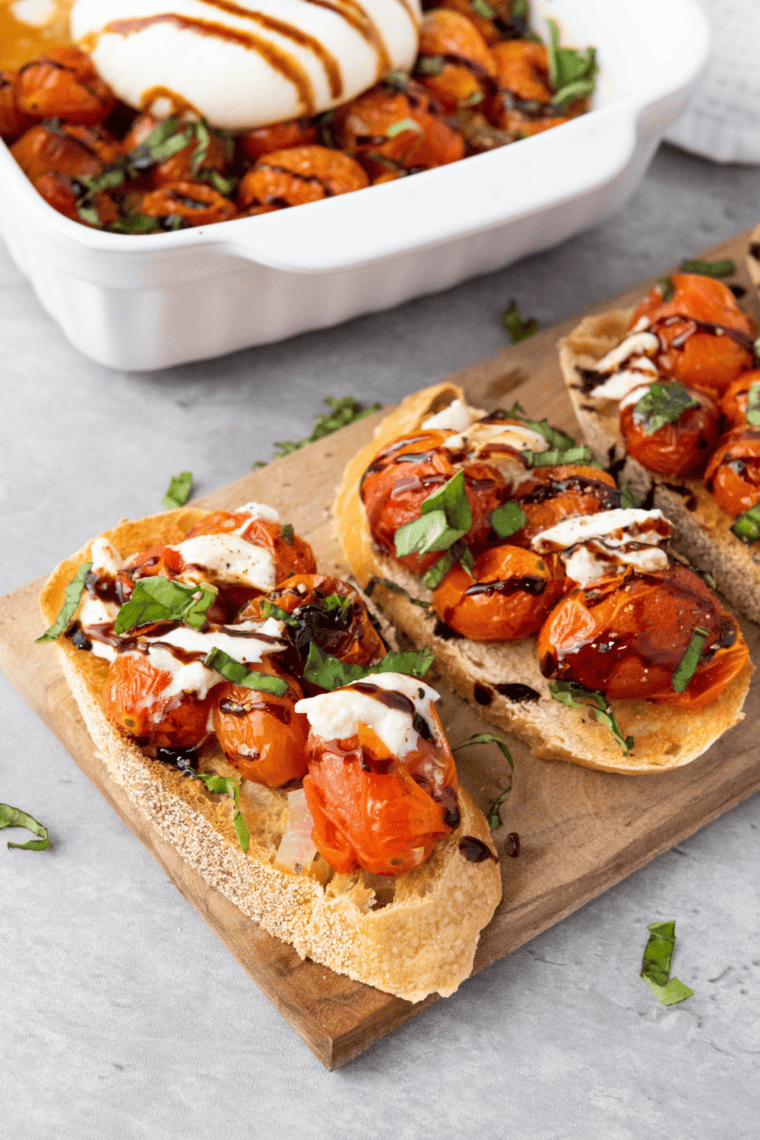 Toasted baguette slices topped with fresh tomatoes, basil, garlic, burrata, and balsamic glaze, making a perfect Copycat Olive Garden Bruschetta.