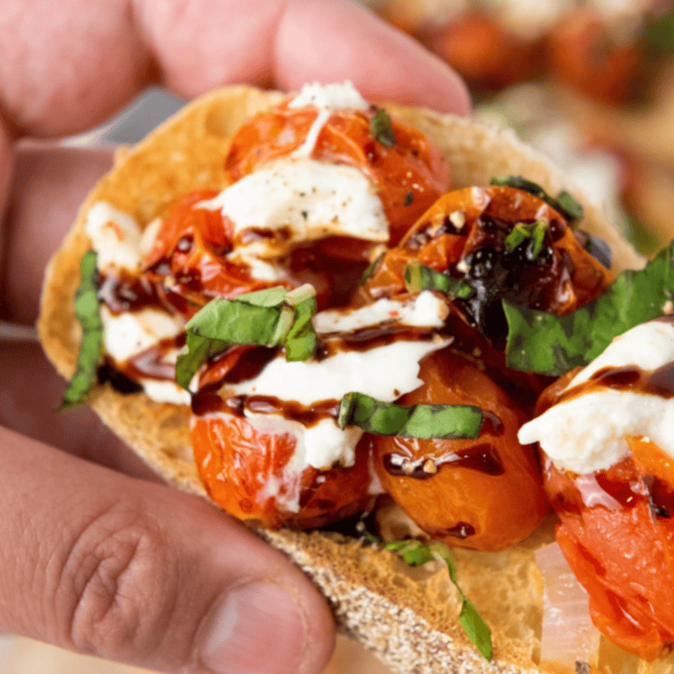Toasted baguette slices topped with fresh tomatoes, basil, garlic, burrata, and balsamic glaze for a delicious Copycat Olive Garden Bruschetta.