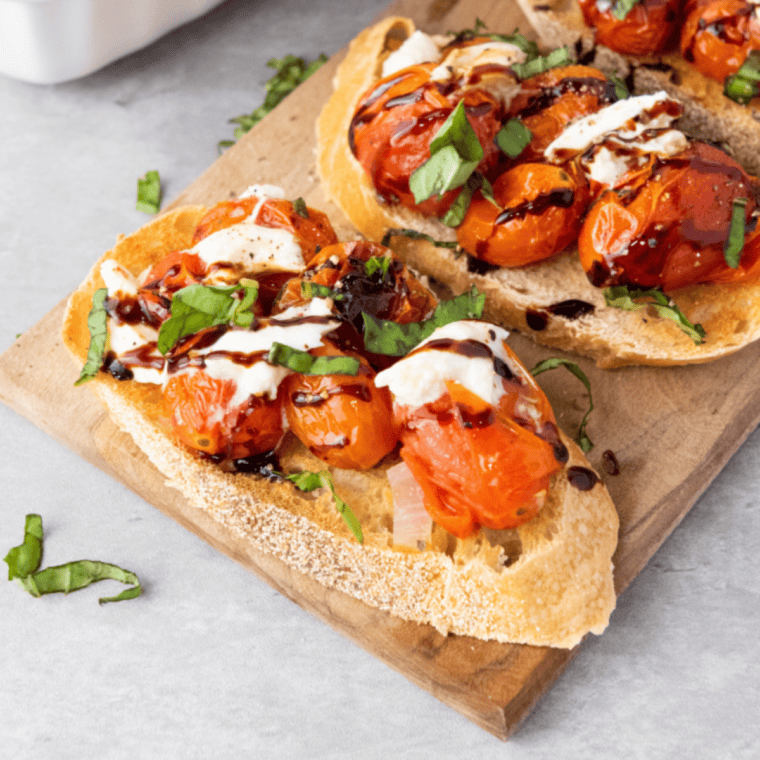 Toasted baguette slices topped with fresh tomatoes, basil, garlic, burrata, and a drizzle of balsamic glaze for a delicious Copycat Olive Garden Bruschetta.