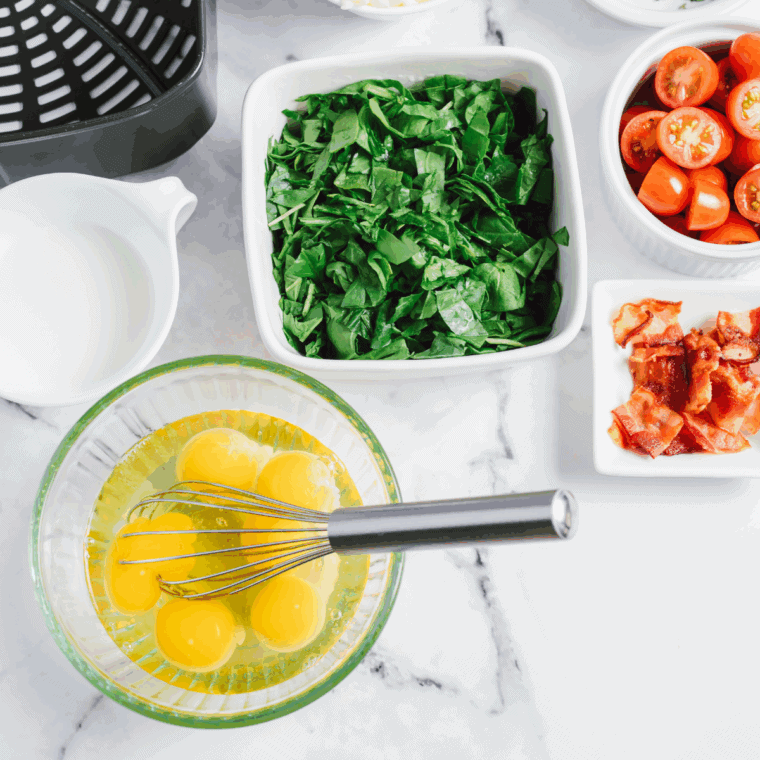 Crack eggs into a mixing bowl.