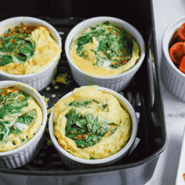 Air Fryer Spinach and Tomato Frittata with fresh spinach, cherry tomatoes, and melted cheese in a golden, fluffy frittata cooked in the air fryer.