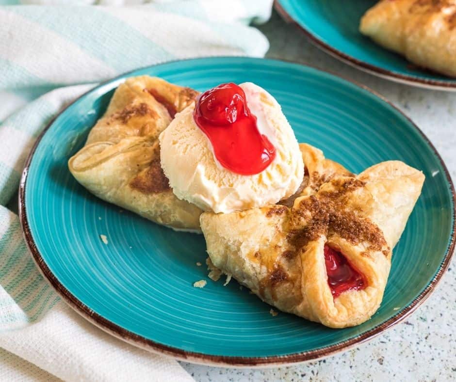 Air Fryer Best Cherry Turnovers on Plate with Ice Cream and Cherry Pie Filling