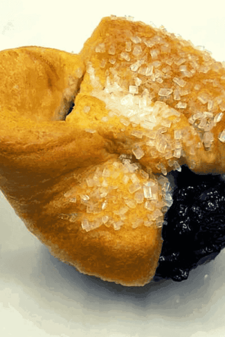 Golden air fryer blueberry crescent roll muffins with flaky layers and sweet blueberry filling, freshly baked and ready to enjoy.