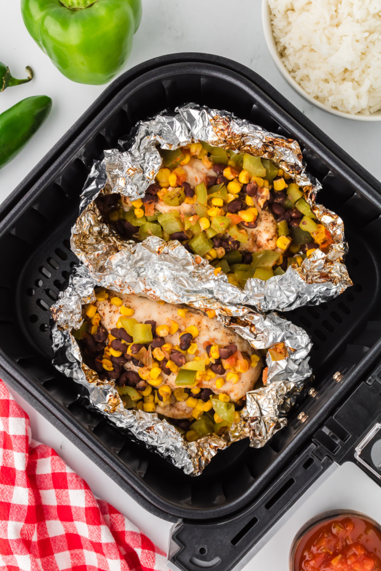 "Close-up of juicy chicken and vegetables from air fryer Mexican chicken foil packet"