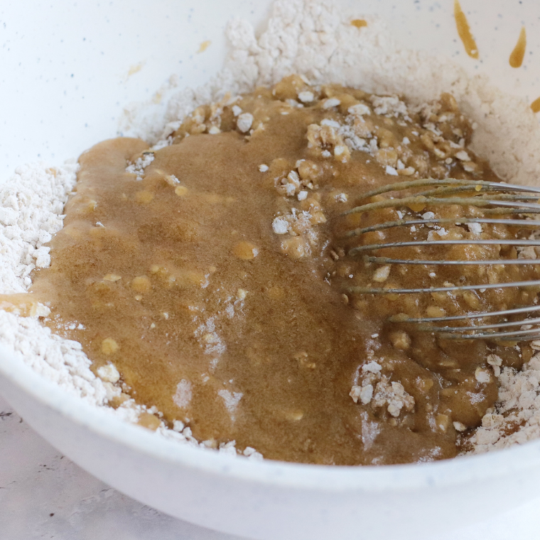 Mixing the cookie batter in a large white bowl. Mix until well blended.