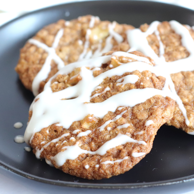 "Golden brown Air Fryer Pumpkin Oatmeal Cookies stacked on a plate, showcasing their soft and chewy texture, with oats and dried cranberries visible."