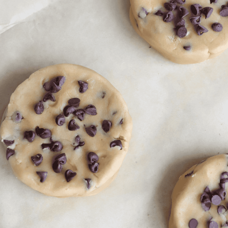 Air fryer with cookie dough cooking at 320&deg;F, cookies beginning to brown.
