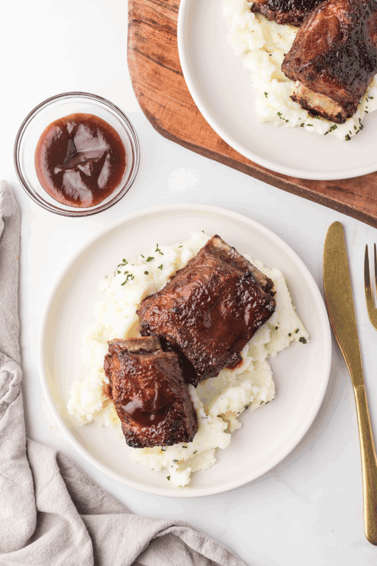 Crispy air fryer Korean short ribs served with sesame seeds and scallions.