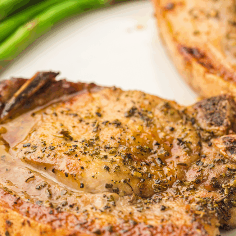 Delicious Easy Mexican Pork Chops seasoned with spices, cooked in the air fryer, served with lime and cilantro.
