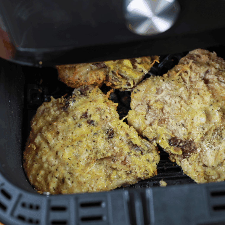 Close up of Outback Steakhouse Parmesan Crusted Pork Chops Copycat in air fryer basket.