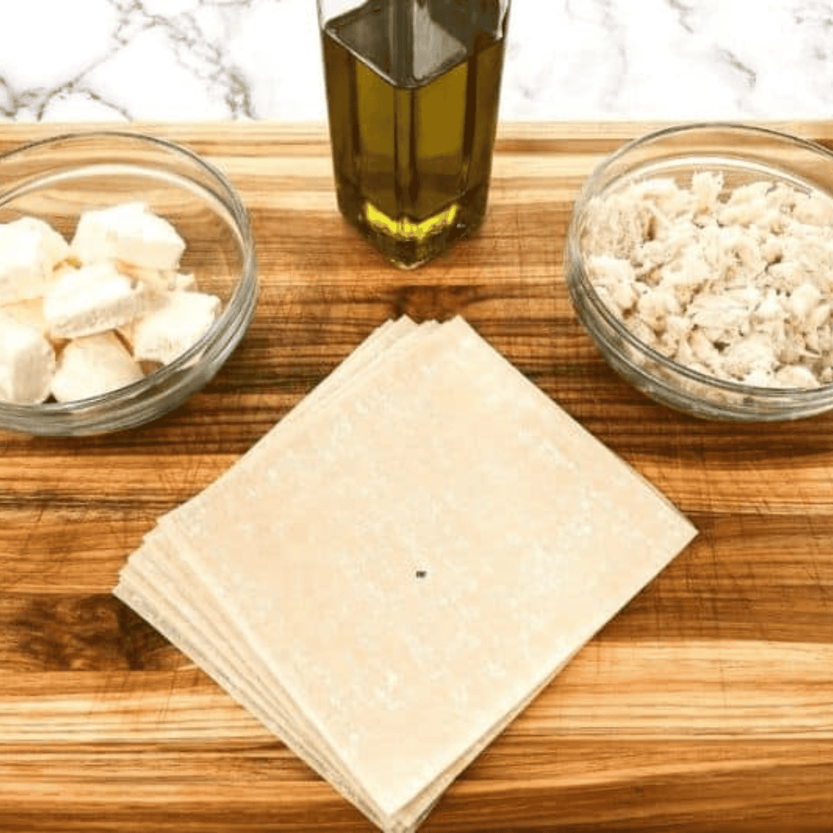 Ingredients needed for P.F. Chang’s Crab Rangoons Recipe on kitchen table.