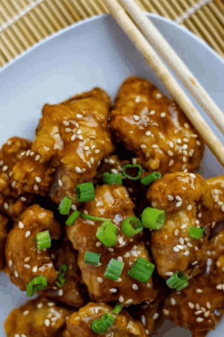 Crispy sweet and sour chicken coated in vibrant sauce served with steamed rice and vegetables.