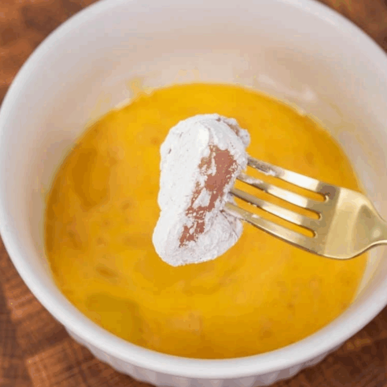 Coat the breaded chicken into the egg mixture.