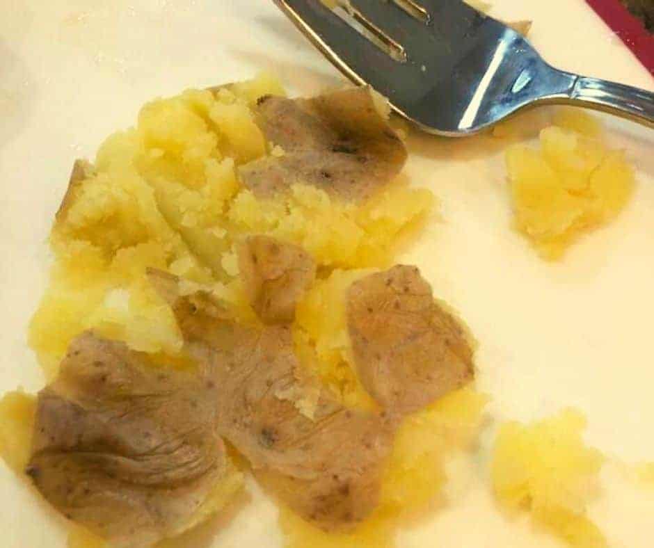 extreme closeup: mashed potatoes on a plate with a fork