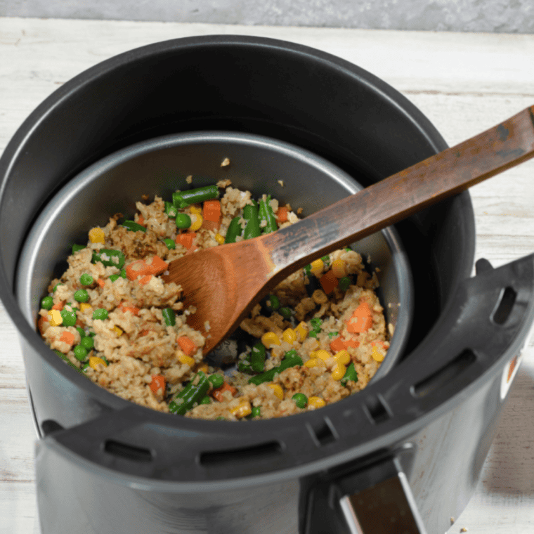 Freshly cooked air fryer fried cauliflower rice with mixed vegetables in a white bowl, ready to serve