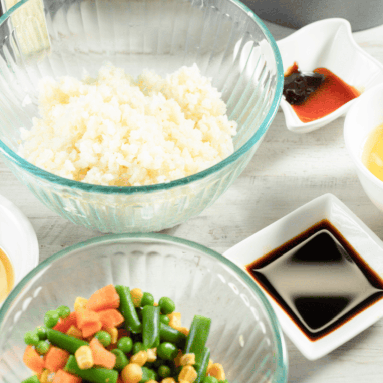 Whisking soy sauce, sesame oil, rice wine vinegar, and black pepper together in a medium bowl for air fryer cauliflower rice recipe