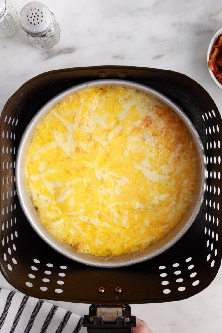 Creamy mashed potatoes made in air fryer, fluffy no-boil side dish in bowl with butter melted on top smooth and rich texture.