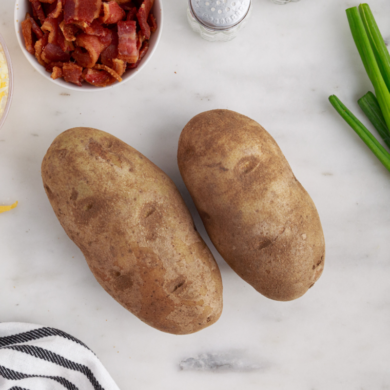 Clean potatoes scrubbed under cold water then dried and pierced with fork before cooking in air fryer